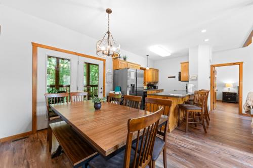 a kitchen and dining room with a wooden table and chairs at 6BD 6BT New Clubhouse indoor pool 1 min to SDC in Branson