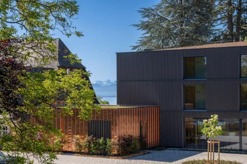 an external view of a house with a wooden facade at Seegut Zeppelin in Friedrichshafen
