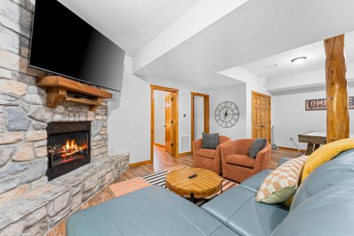a living room with a couch and a fireplace at 6BD 6BT New Clubhouse indoor pool 1 min to SDC in Branson