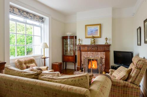 a living room with two couches and a fireplace at The Old Surgery in Limavady