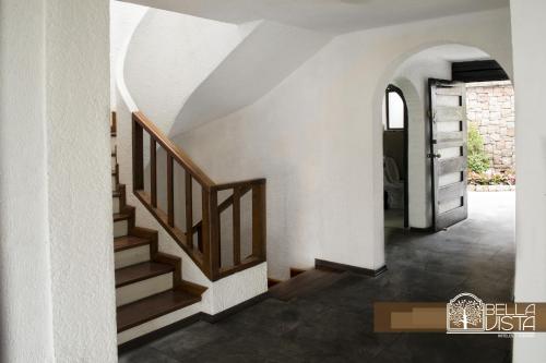 a hallway with stairs and an archway in a house at Hotel Bellavista Quito in Quito