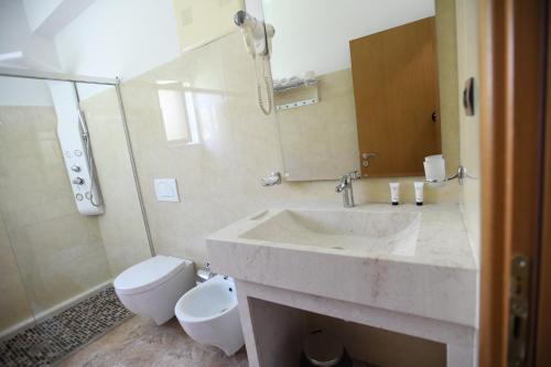 a bathroom with a sink and a toilet at Hotel Gega in Berat