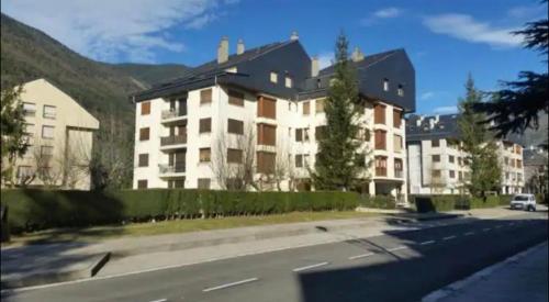 a large building on the side of a street at Apart acogedor en Biescas para familias,vistas a la montaña in Biescas