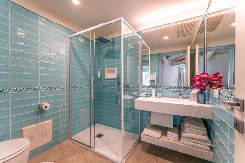 a bathroom with a glass shower and a sink at Oasi Blu Sardinia in Santa Margherita di Pula