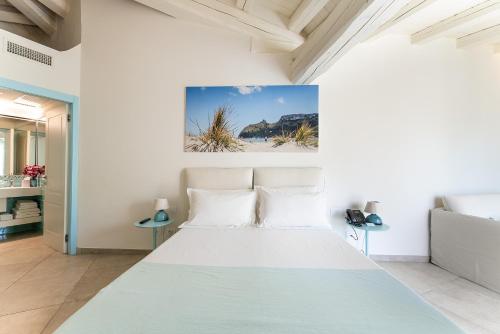 a bedroom with a large bed in a room at Oasi Blu Sardinia in Santa Margherita di Pula