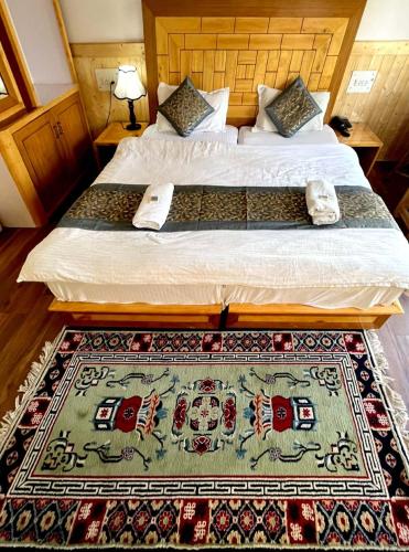 a bedroom with a bed with a rug on it at Hotel Namgyal Villa in Nubra
