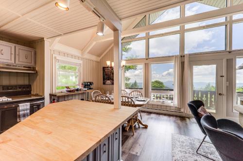 a kitchen with a large table and chairs and windows at 1 Mi to Beech Mtn Ski Resort Home with Large Yard in Beech Mountain