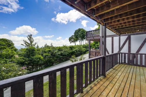 a balcony of a house with a wooden deck at 1 Mi to Beech Mtn Ski Resort Home with Large Yard in Beech Mountain