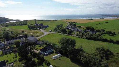 an aerial view of a house in a green field at Ty Queff Lodge in Plonévez-Porzay