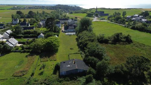 an aerial view of a house in a green field at Ty Queff Lodge in Plonévez-Porzay