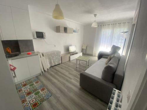 a living room with a couch and a table at Apart acogedor en Biescas para familias,vistas a la montaña in Biescas