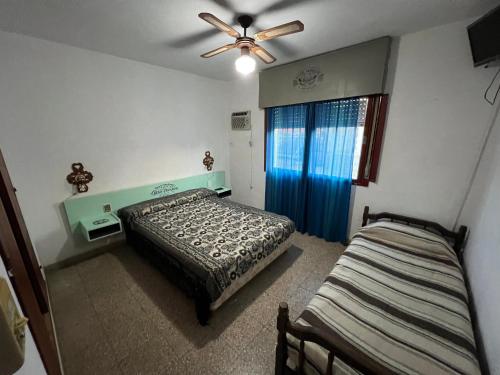 a bedroom with a bed and a ceiling fan at Cybeles Family Apart in Villa Carlos Paz