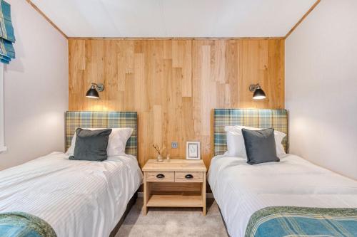 two beds sitting next to each other in a room at Aberdunant Hall in Porthmadog