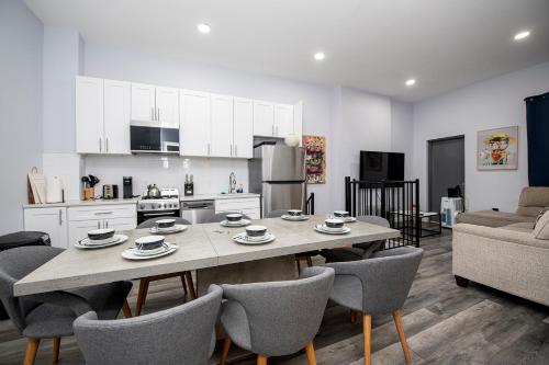a kitchen and living room with a table and chairs at Spectacular Times Square 5 Bedroom Duplex Oasis in New York