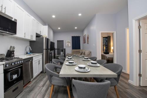 a kitchen and dining room with a table and chairs at Spectacular Times Square 5 Bedroom Duplex Oasis in New York