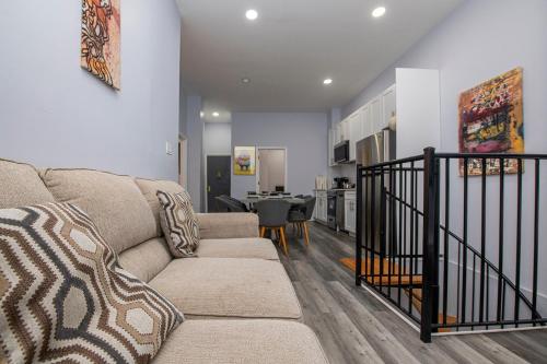 a living room with a couch and a table at Spectacular Times Square 5 Bedroom Duplex Oasis in New York