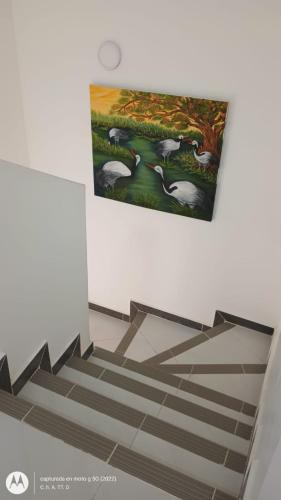 a painting of a staircase with a painting of birds at Casa Farallones a 20 minutos de Cali, Negocios, Familia, Casa tranquila, ideal para trabajos temporales o ejecutivos en la zona, descanso, privacidad, excelente señal wifi in Jamundí
