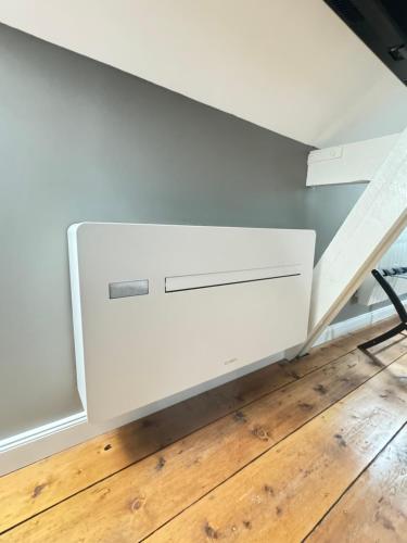 a white cabinet in a room with a wooden floor at Aura Castle in Picquigny