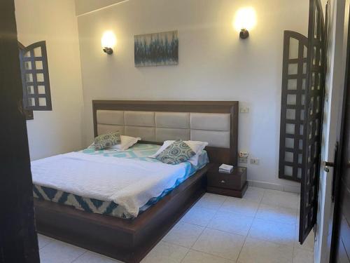 a bedroom with a bed with a wooden frame at Chalet 3 room marina 5 in El Alamein