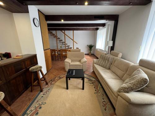 a living room with a couch and chairs and a table at Rodinný dům Poděbrady in Poděbrady