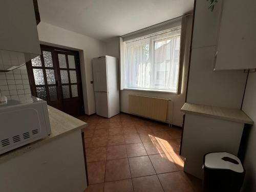 a kitchen with a white refrigerator and a window at Rodinný dům Poděbrady in Poděbrady