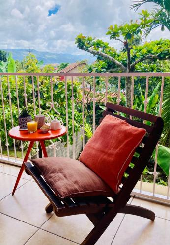 a chair sitting on a balcony with a table at Boutique Hotel Casa de Lis, Turrialba in Turrialba