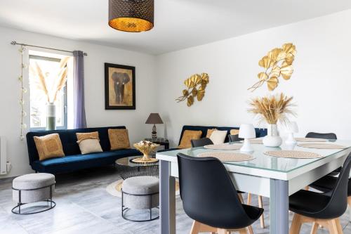 a living room with a table and chairs at Le Gite - Ladaux in Ladaux