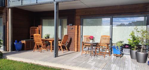 a patio with a table and chairs on a deck at Entire Home - Unique Quiet Quality Near the Sea in Horten