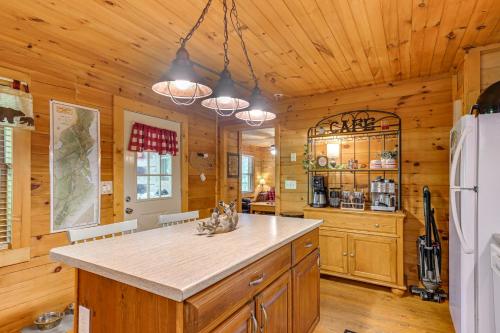 a kitchen with wooden walls and a large island in a room at Pet-Friendly Bryson City Cabin with Fire Pit and Deck! in Bryson City