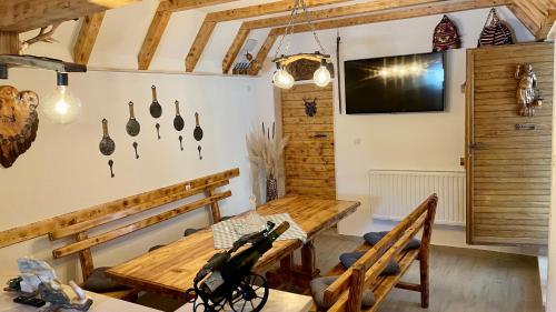 a dining room with a wooden table and a tv at Holiday Home Leon - Imotski - Makarska in Drum