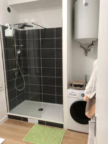 une douche avec une porte vitrée dans une salle de bain dans l'établissement T3 refait à neuf, lumineux et confortable, à Toulon