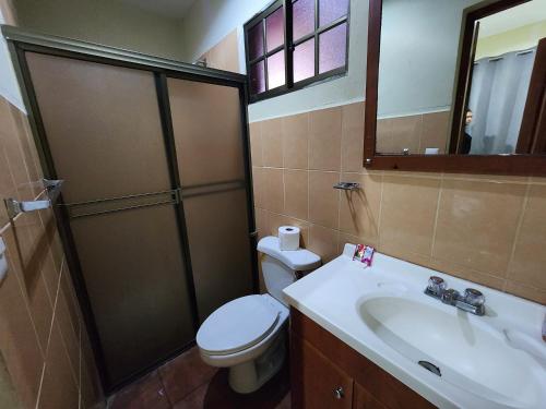 a bathroom with a toilet and a sink and a shower at Hotel Casona Macondo, Granada, Nicaragua in Granada