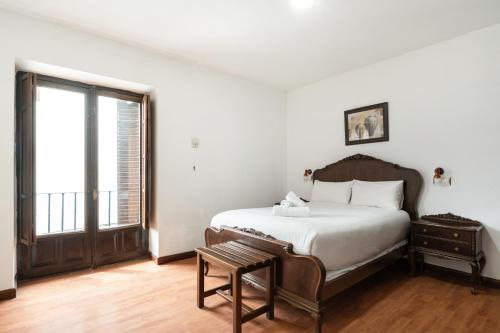 a bedroom with a large bed and a window at Hotel La Quinta de Santillán in Chinchón