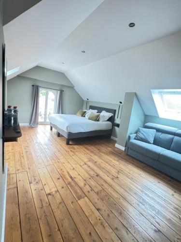a living room with a bed and a couch at Aura Castle in Picquigny