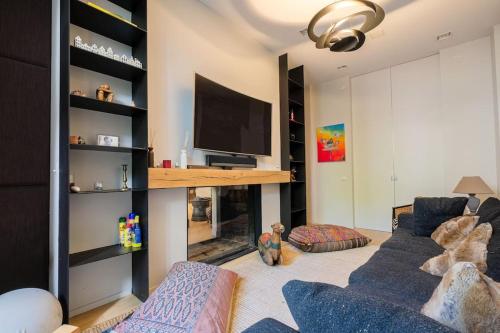 a living room with a couch and a flat screen tv at The Retreat in Brussels