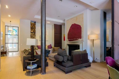 a living room with a couch and a fireplace at The Retreat in Brussels