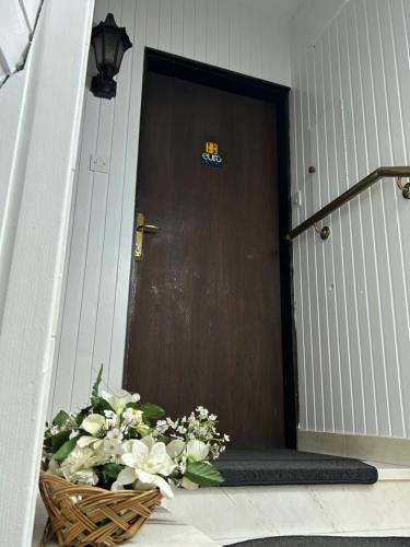 a basket of flowers sitting in front of a door at Hondo Rooms & Apartments in Sarajevo