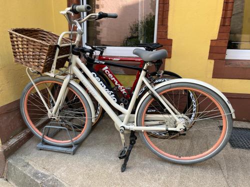 a bicycle with a basket parked next to a building at Modern Stay I Cosy & Central Apartments in Koblenz