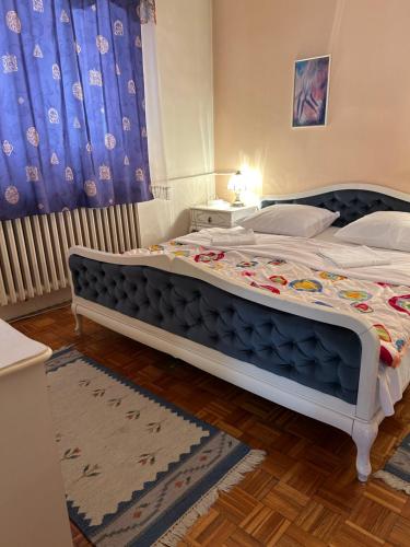 a bedroom with a large bed in a room at Hondo Rooms & Apartments in Sarajevo