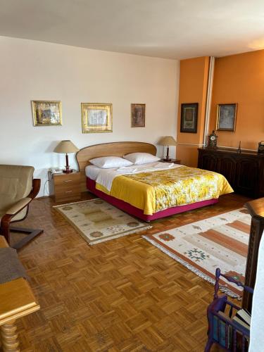a bedroom with a bed and two tables and two lamps at Hondo Rooms & Apartments in Sarajevo