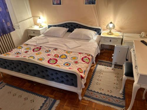 a bedroom with a large bed and two night stands at Hondo Rooms & Apartments in Sarajevo
