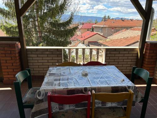 a table and chairs on a patio with a view at Hondo Rooms & Apartments in Sarajevo