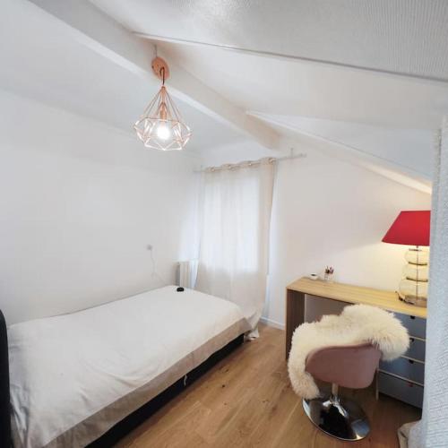 une chambre avec un lit, un bureau et une chaise dans l'établissement un appartement individuel dans une maison proche de Paris avec un accès facile aux transports en commun, au Plessis-Robinson