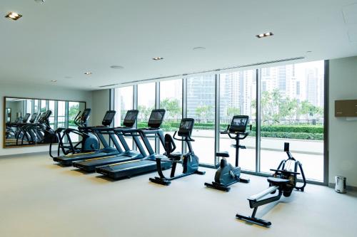 a gym with treadmills and elliptical machines at Burj Crown - Downtown Elegance Opera Boulevard View by Dubai Mall in Dubai