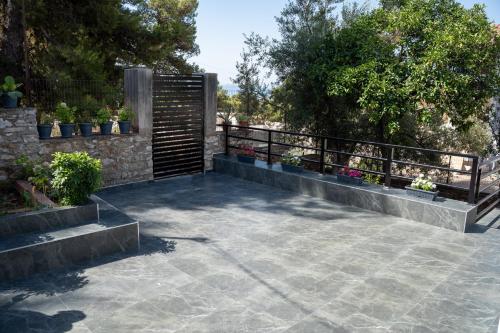 a patio with potted plants and a fence at Sunnydream Apartaments Saranda in Sarandë