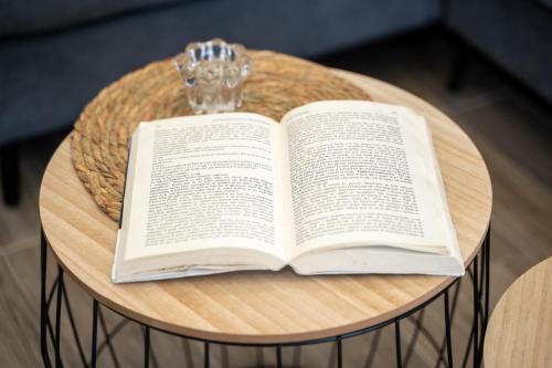 an open book sitting on a round table at Sunnydream Apartaments Saranda in Sarandë