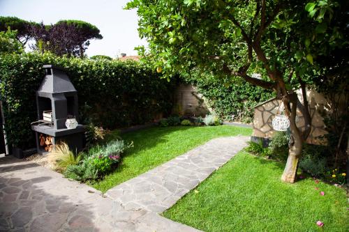 a garden with a lantern in the grass at Roussev Apartment - Coastal Gem - Anzio in Anzio