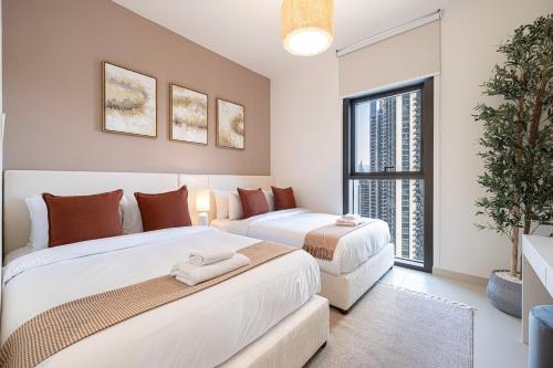a bedroom with two beds and a window at Burj Crown - Downtown Elegance Opera Boulevard View by Dubai Mall in Dubai