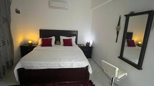 a bedroom with a large bed and a mirror at Bait Al-Masri in Um Qeis
