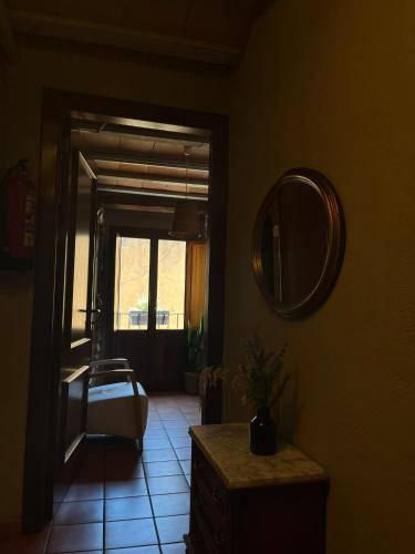 a bathroom with a sink and a mirror and a window at Cal Blasi in Montblanc